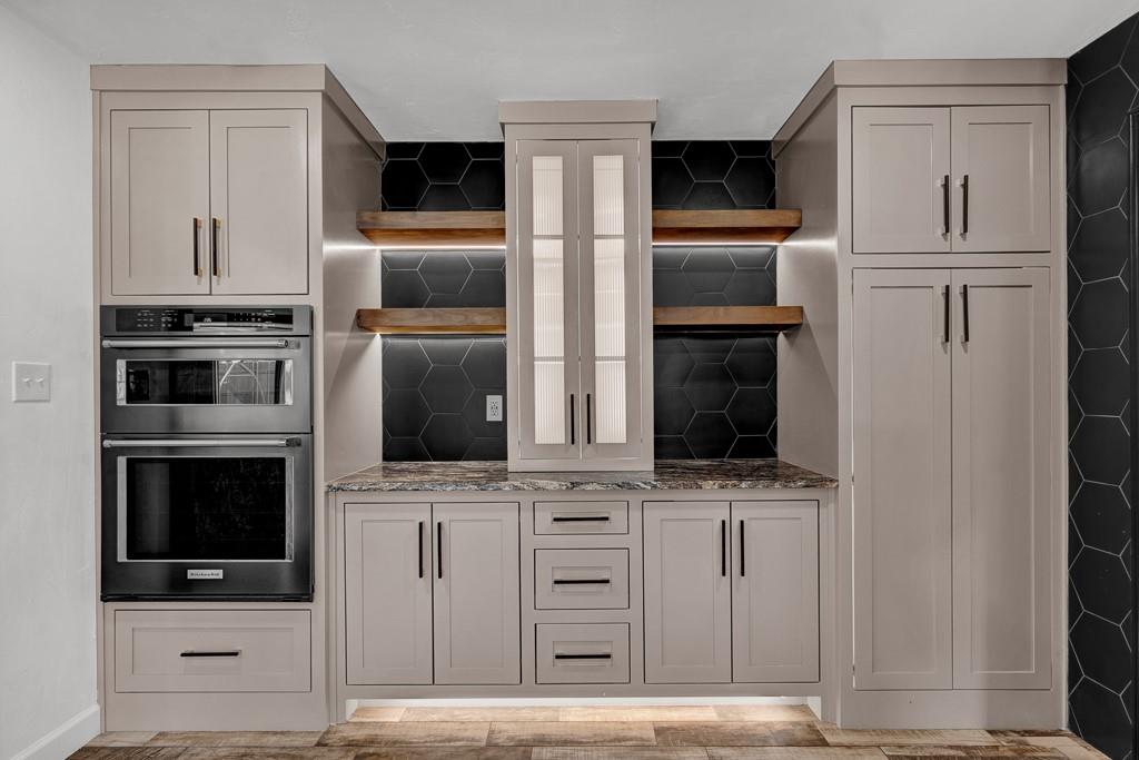 6117 Gainsborough Road Amarillo, TX 79106 - Photo 13 of 40 a kitchen with white cabinets and stainless steel appliances