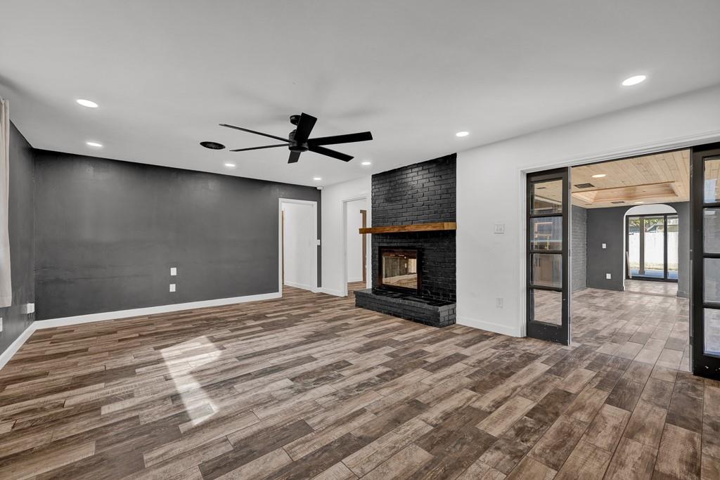 6117 Gainsborough Road Amarillo, TX 79106 - Photo 24 of 40 a view of an empty room with a fireplace and a window