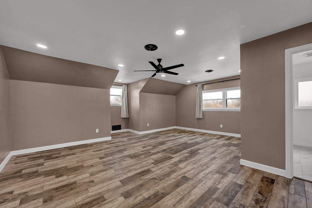 6117 Gainsborough Road Amarillo, TX 79106 - Photo 29 of 40 a view of an empty room with window and wooden floor