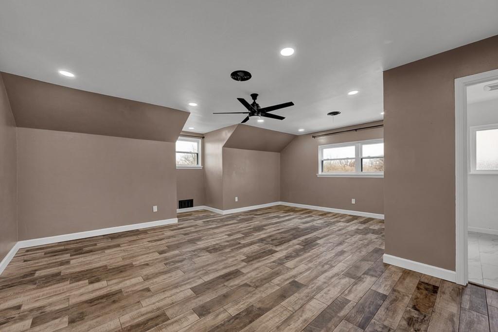 6117 Gainsborough Road Amarillo, TX 79106 - Photo 34 of 40 a view of an empty room with window and wooden floor