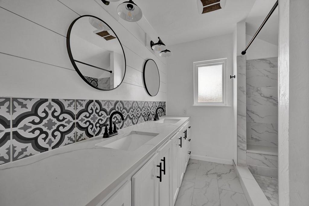 6117 Gainsborough Road Amarillo, TX 79106 - Photo 35 of 40 a bathroom with a sink and a mirror