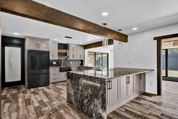 a kitchen with stainless steel appliances granite countertop a sink stove and refrigerator