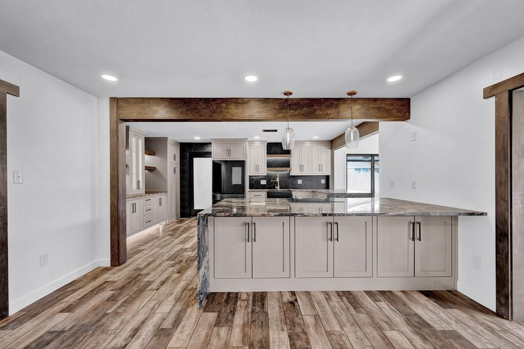 6117 Gainsborough Road Amarillo, TX 79106 - Photo 9 of 40 a kitchen with stainless steel appliances a sink and cabinets