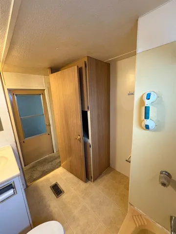 a bathroom with a tub sink and mirror