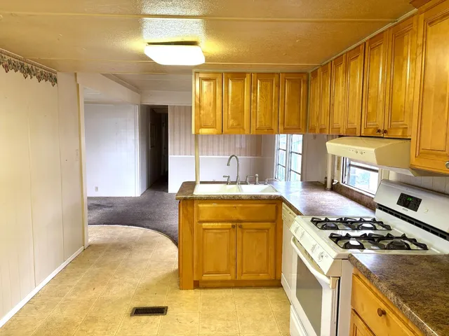 a kitchen with a stove and a refrigerator