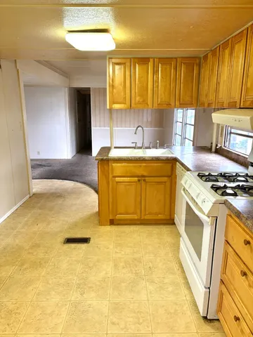 a spacious bathroom with a tub sink and mirror