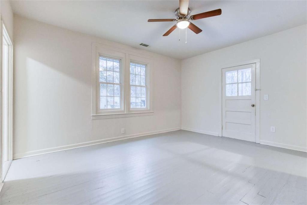 126 6th Street Monroe, GA 30655 - Photo 12 of 24 an empty room with windows and fan