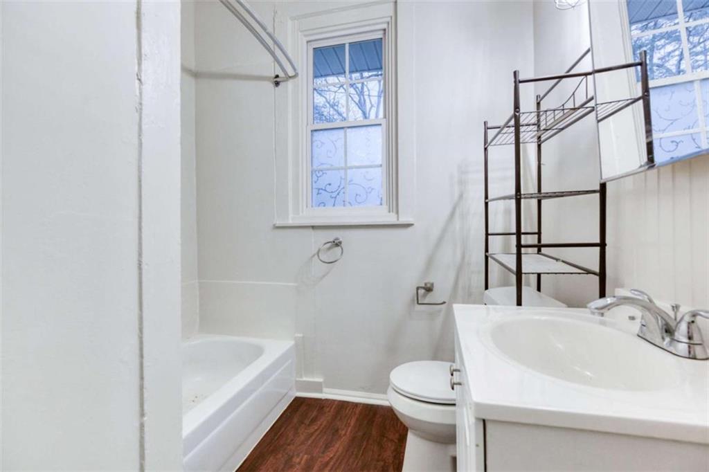 126 6th Street Monroe, GA 30655 - Photo 20 of 24 a bathroom with a sink toilet and bathtub