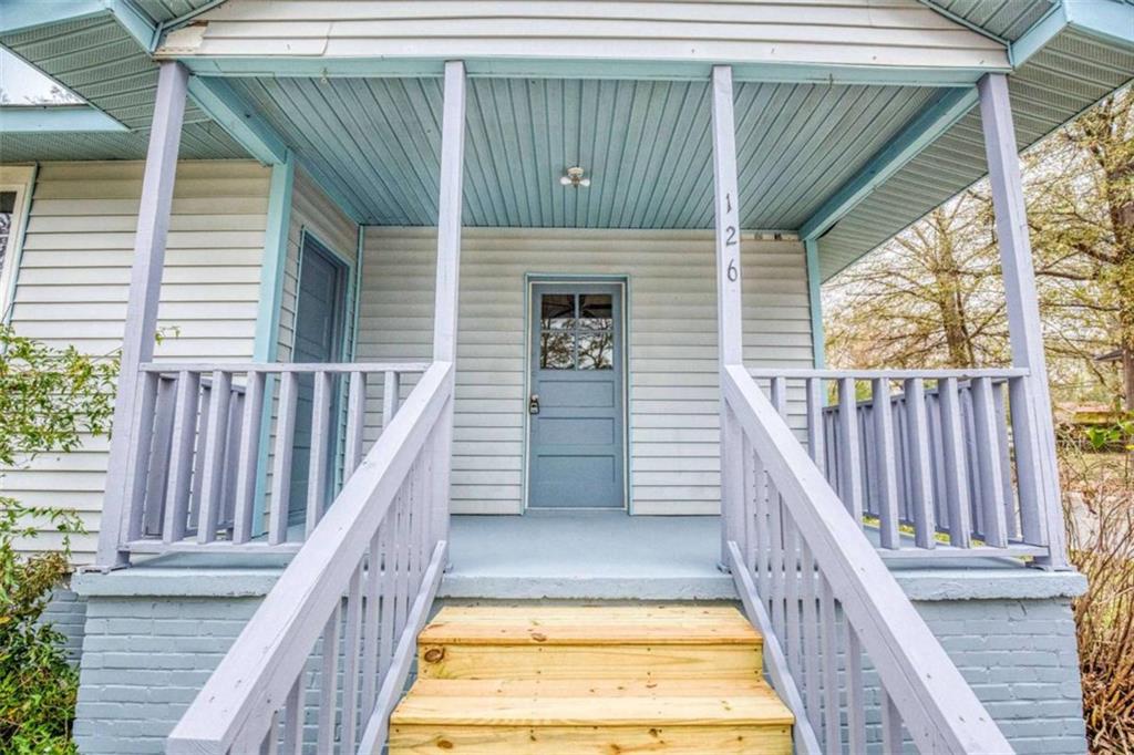 126 6th Street Monroe, GA 30655 - Photo 2 of 24 a view of balcony with wooden floor and fence
