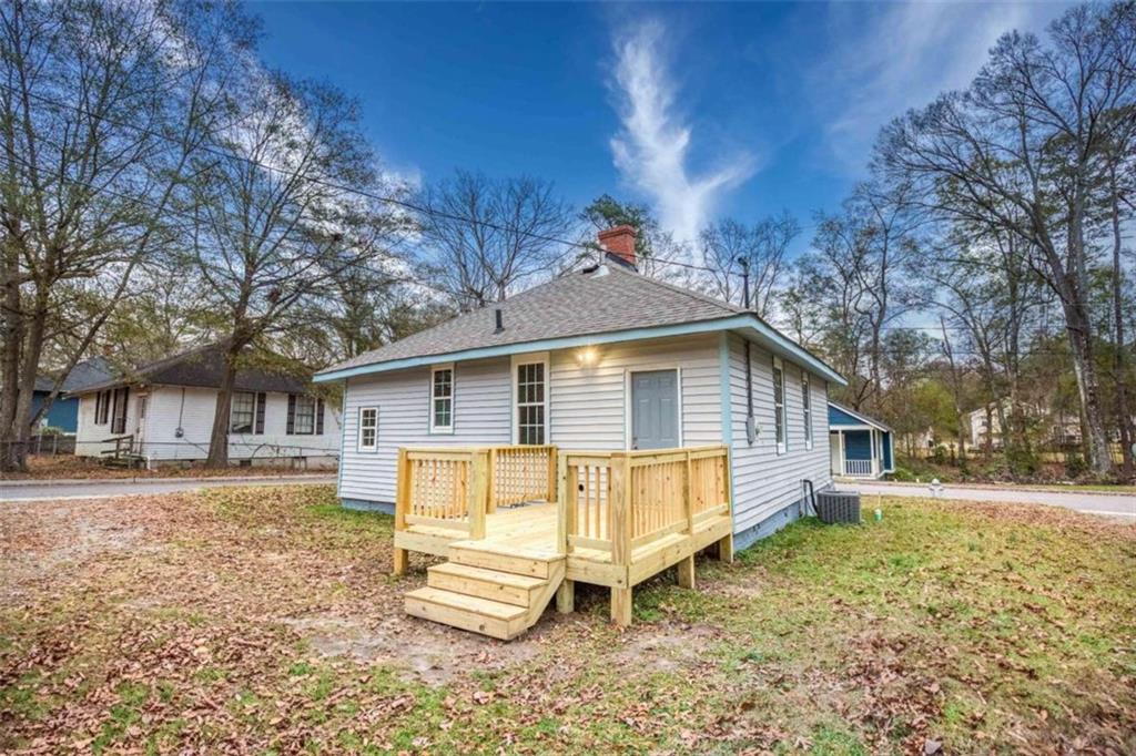 126 6th Street Monroe, GA 30655 - Photo 3 of 24 a view of a house with a yard chairs and floor to ceiling window