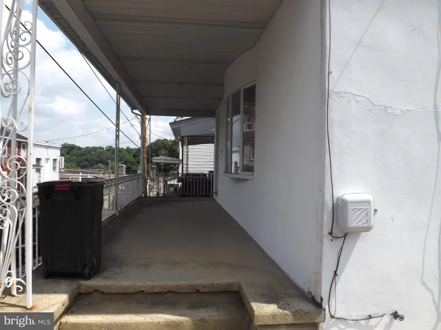 a view of living room with furniture and a floor to ceiling window