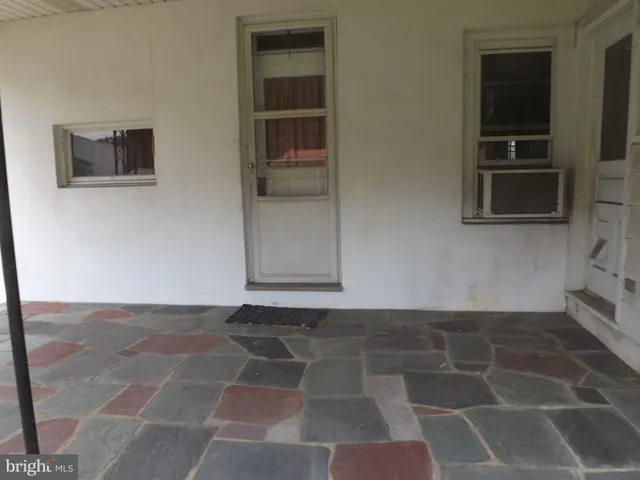 a view of a livingroom with an empty space and a window