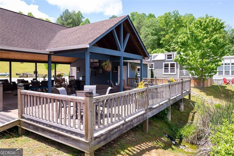121 Mountain Meadows Morganton, GA 30560 - Photo 17 of 28 a view of a house with wooden deck and a garden