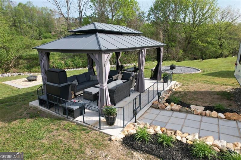 121 Mountain Meadows Morganton, GA 30560 - Photo 7 of 28 a view of a patio with table and chairs under an umbrella