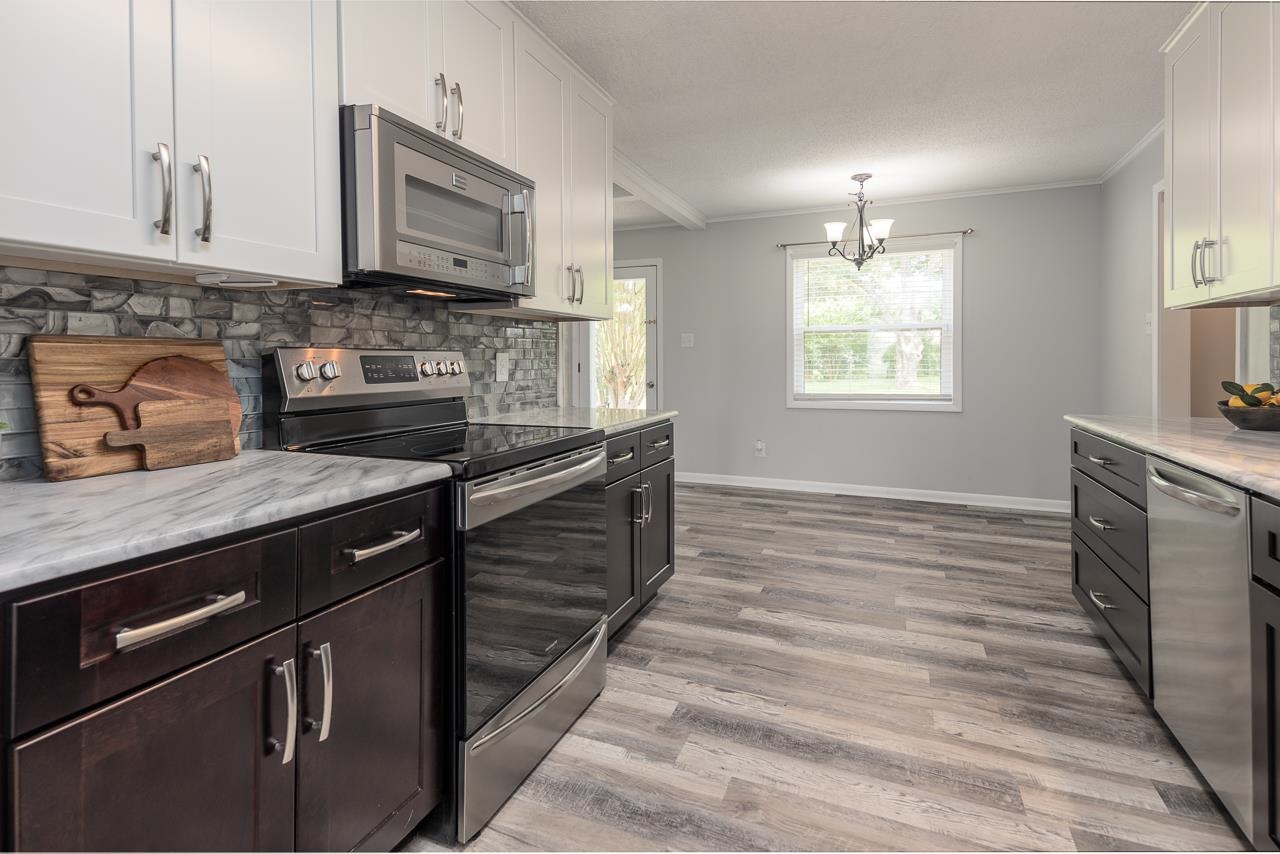 3620 Oak Road Bartlett, TN 38135 - Photo 4 of 28 Kitchen featuring stainless steel appliances, granite countertops, custom backsplash & slow close cabinetry