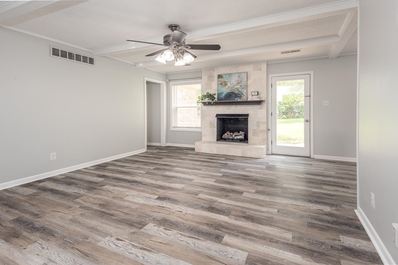 3620 Oak Road Bartlett, TN 38135 - Photo 9 of 28 Spacious Great room featuring ceiling fan, a tile fireplace, beamed ceiling, bright neutral walls and abundant sunlight