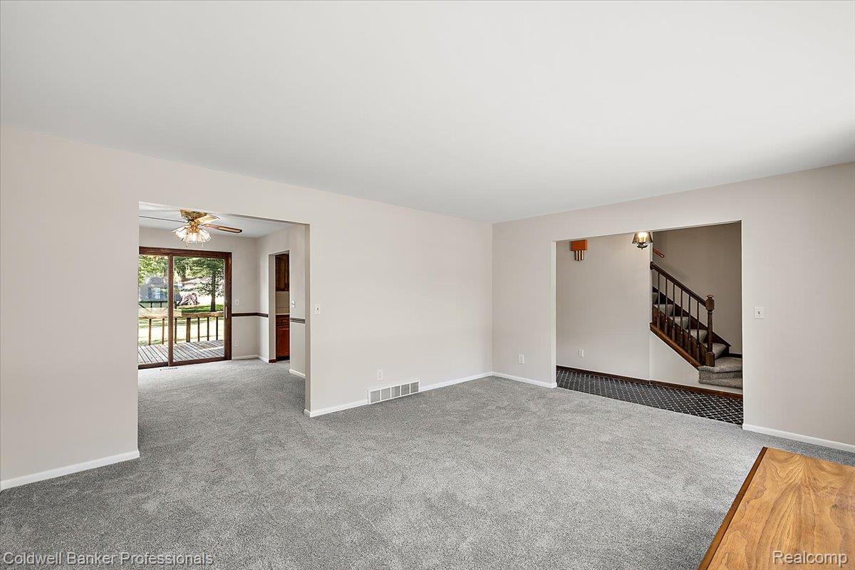 78 Carter Avenue Troy, MI 48098 - Photo 10 of 52 Spare room with carpet, stairs, and a ceiling fan