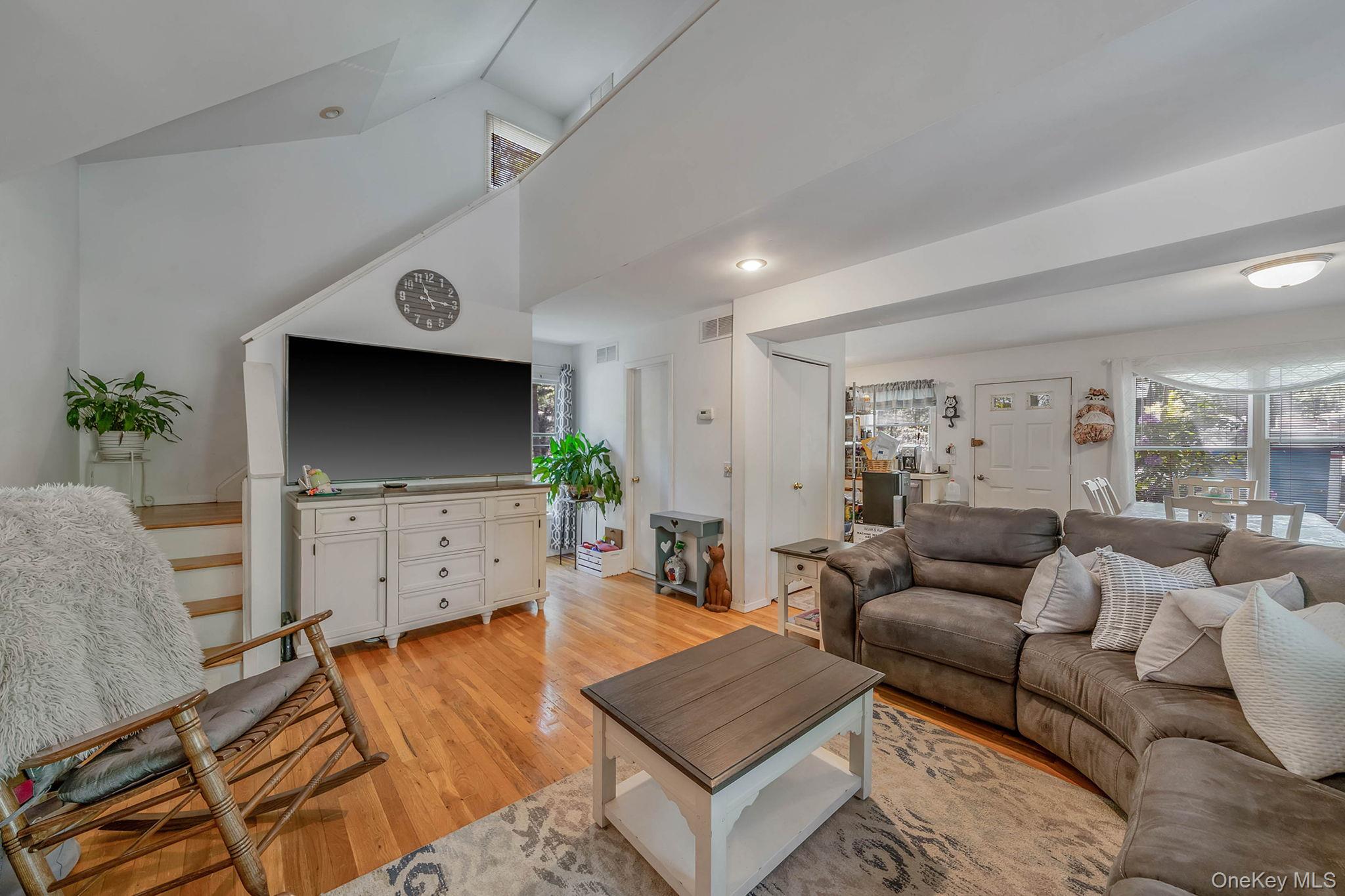 28 Huntting Road East Hampton, NY 11937 - Photo 5 of 14 Living area featuring light wood-style flooring and vaulted ceiling