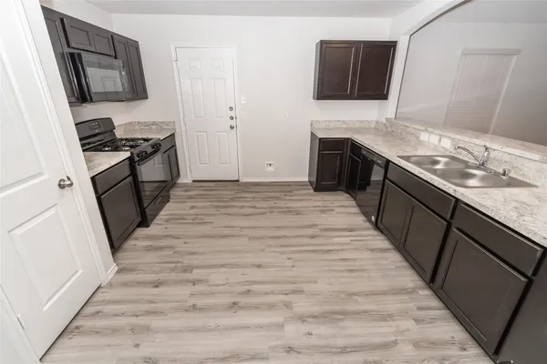 a kitchen with a sink stove and refrigerator
