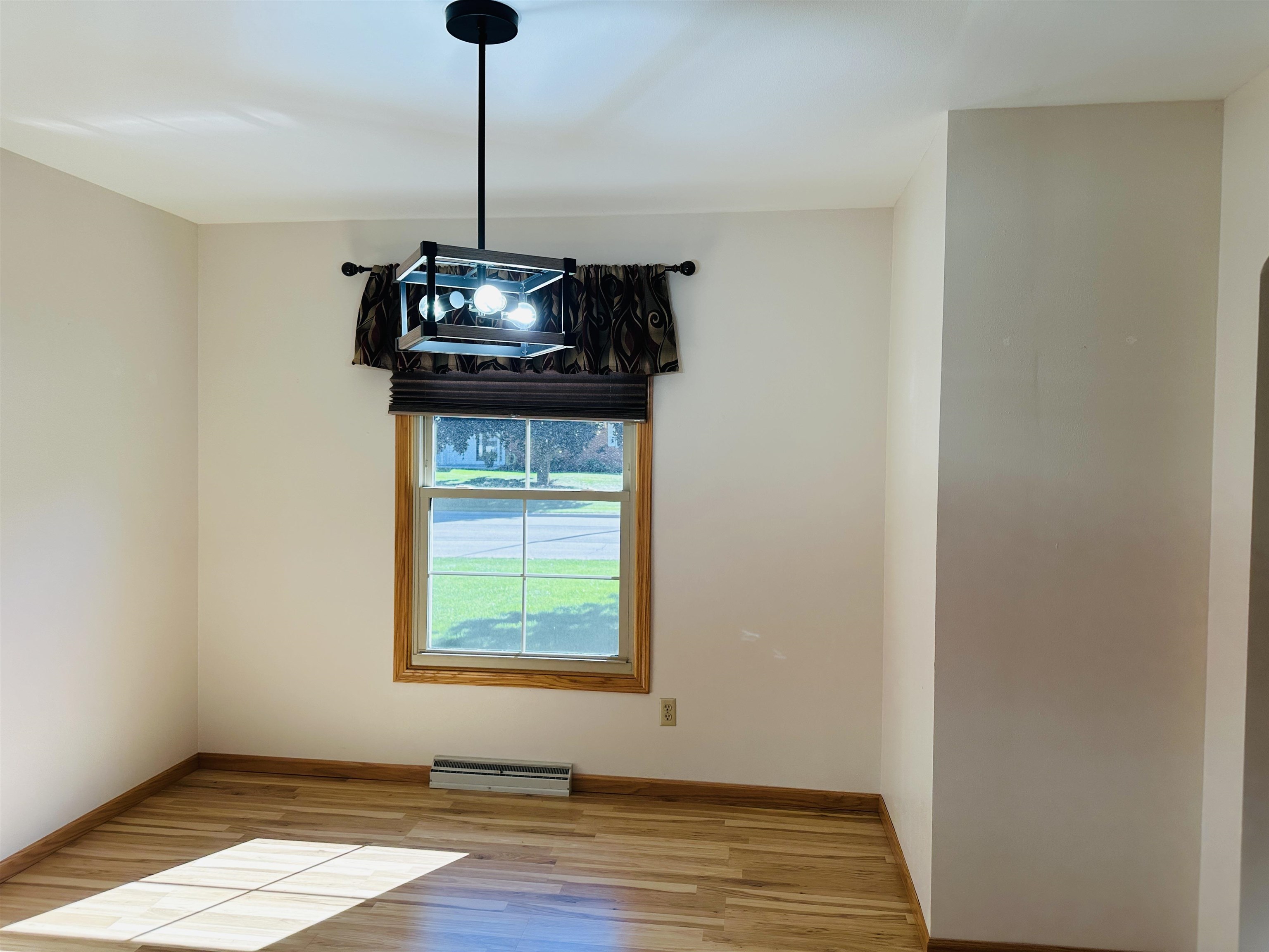 219 Palm Drive Lena, IL 61048 - Photo 12 of 49 a dining room with a window and wooden floor