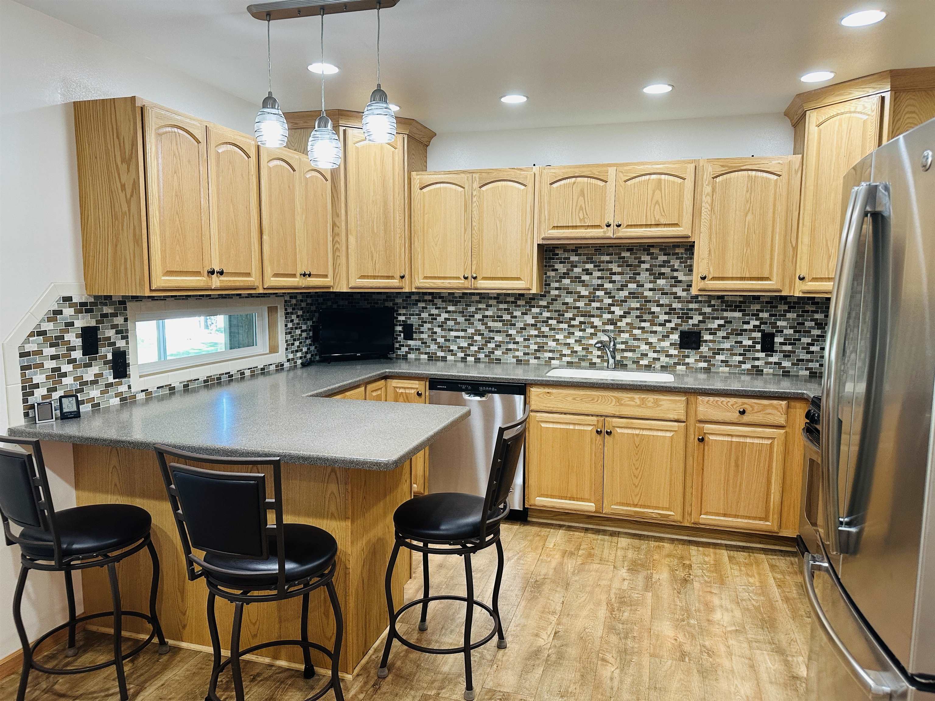 219 Palm Drive Lena, IL 61048 - Photo 13 of 49 a kitchen with stainless steel appliances granite countertop a sink and a refrigerator