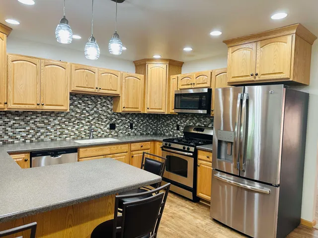 a kitchen with a refrigerator a sink and dishwasher