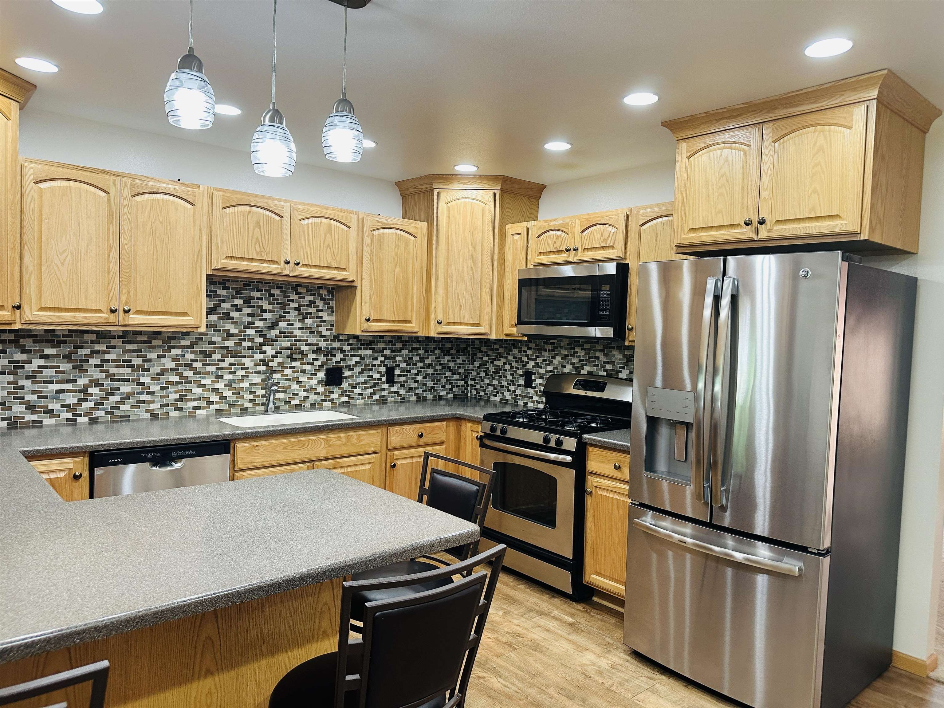 219 Palm Drive Lena, IL 61048 - Photo 14 of 49 a kitchen with stainless steel appliances granite countertop a refrigerator a stove and a sink