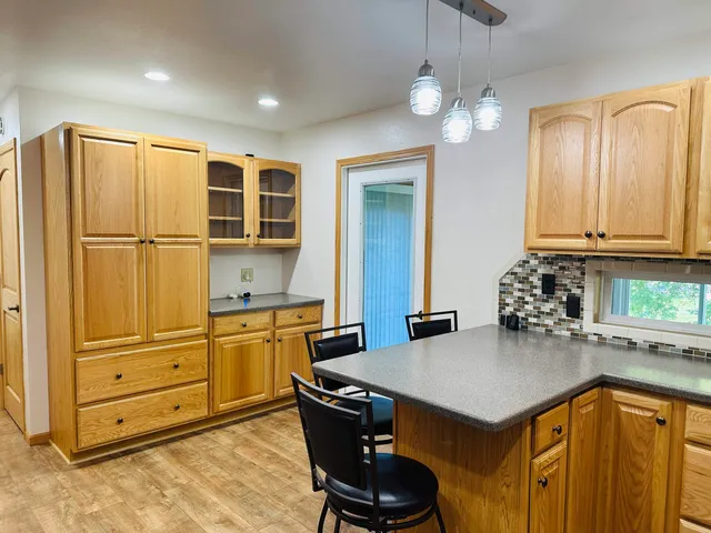 a kitchen with stainless steel appliances granite countertop a sink a stove and cabinets