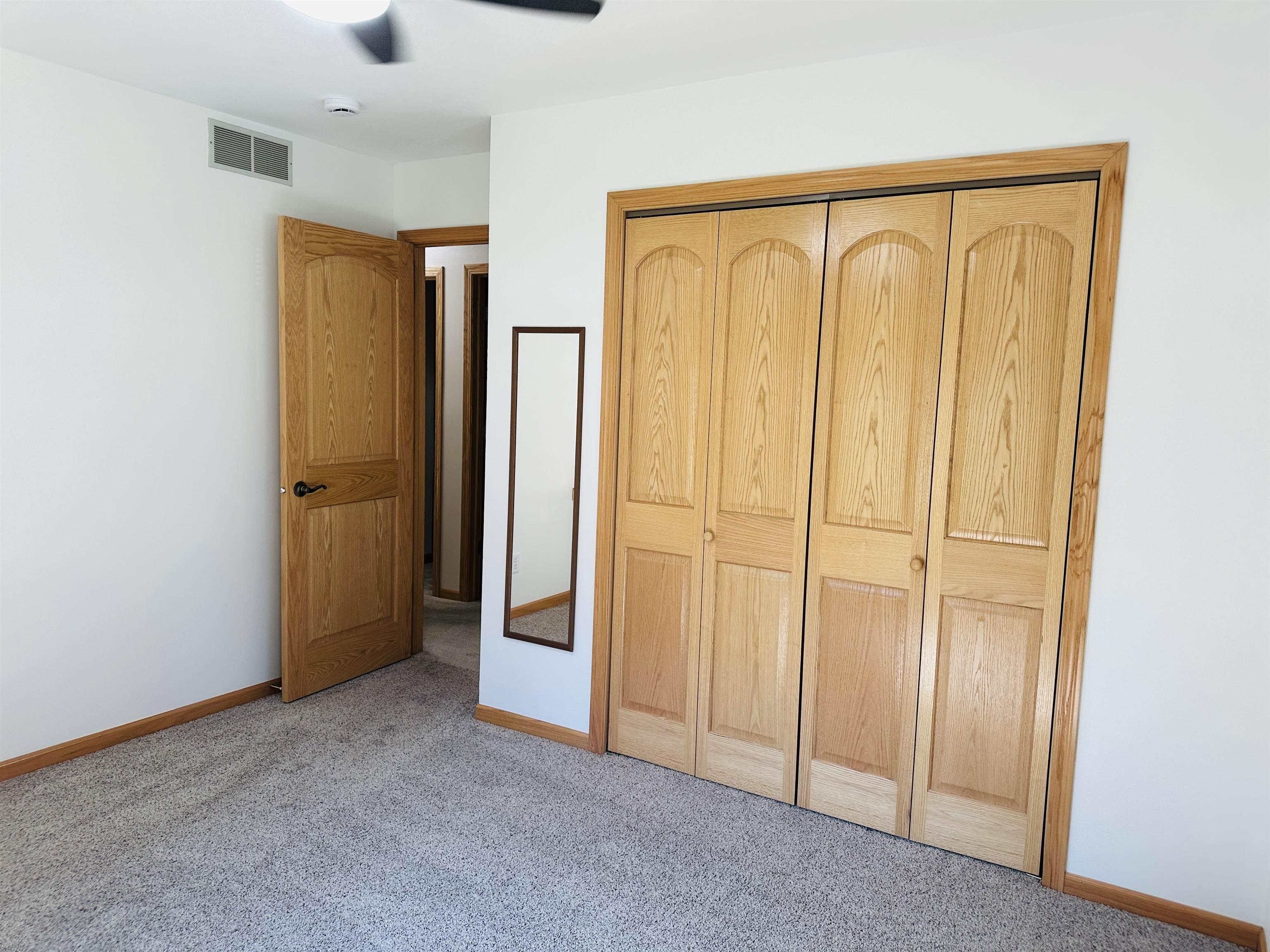 219 Palm Drive Lena, IL 61048 - Photo 28 of 49 an empty room with wooden floor and a window
