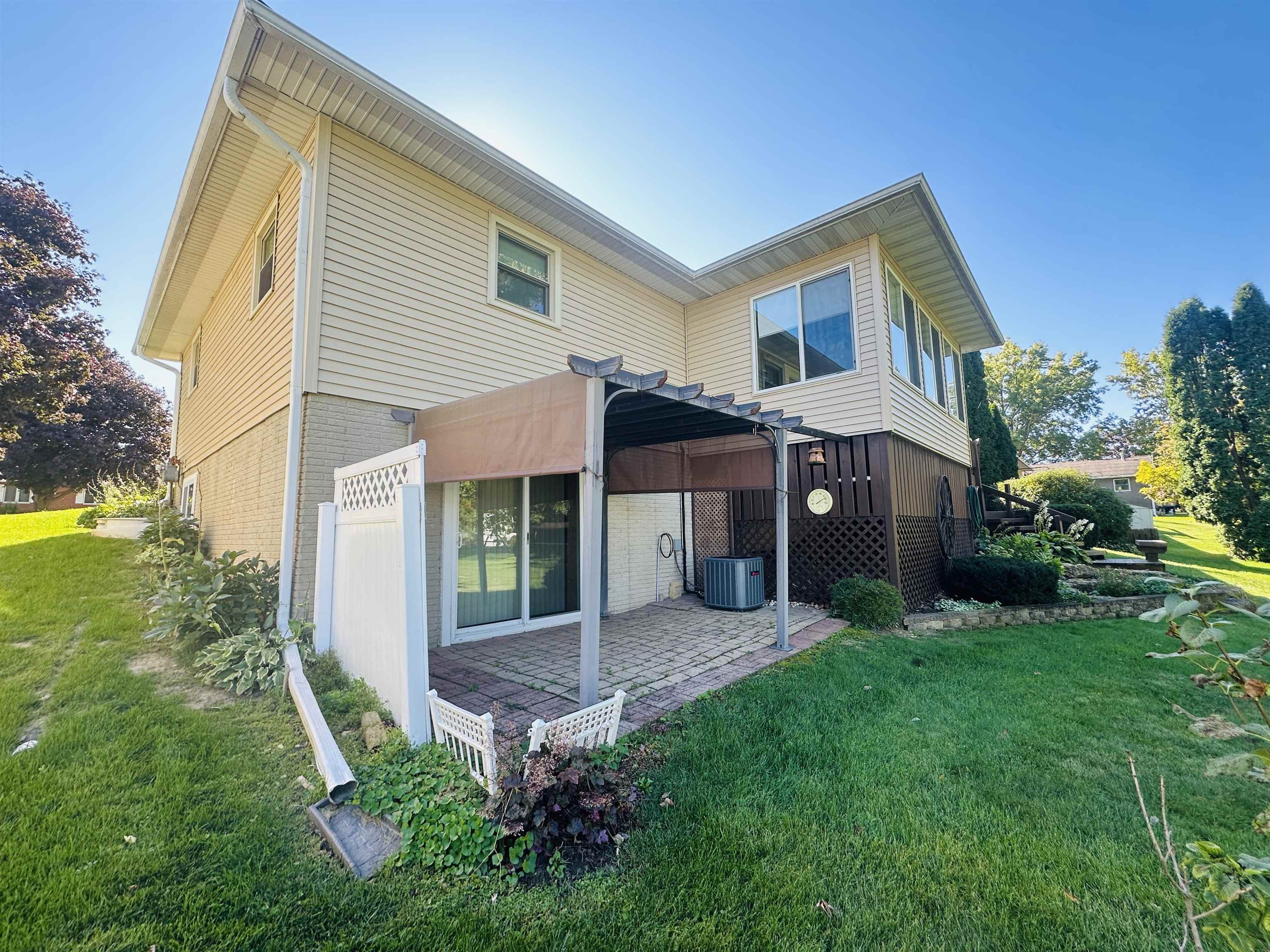 219 Palm Drive Lena, IL 61048 - Photo 48 of 49 a view of a house with a yard and porch