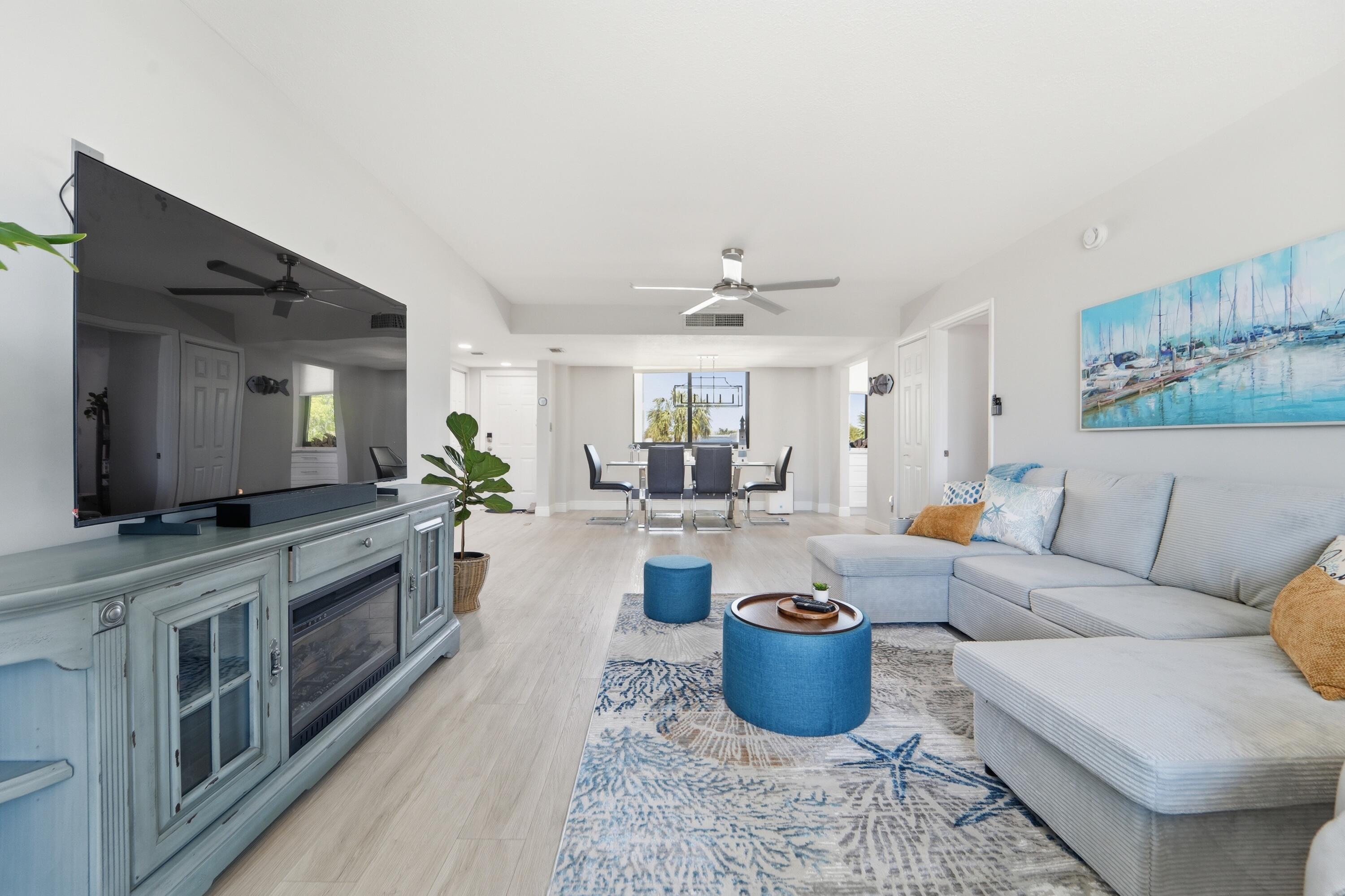 1605 Highway 1, Unit 303M1 Jupiter, FL 33477 - Photo 11 of 42 a living room with furniture and a flat screen tv