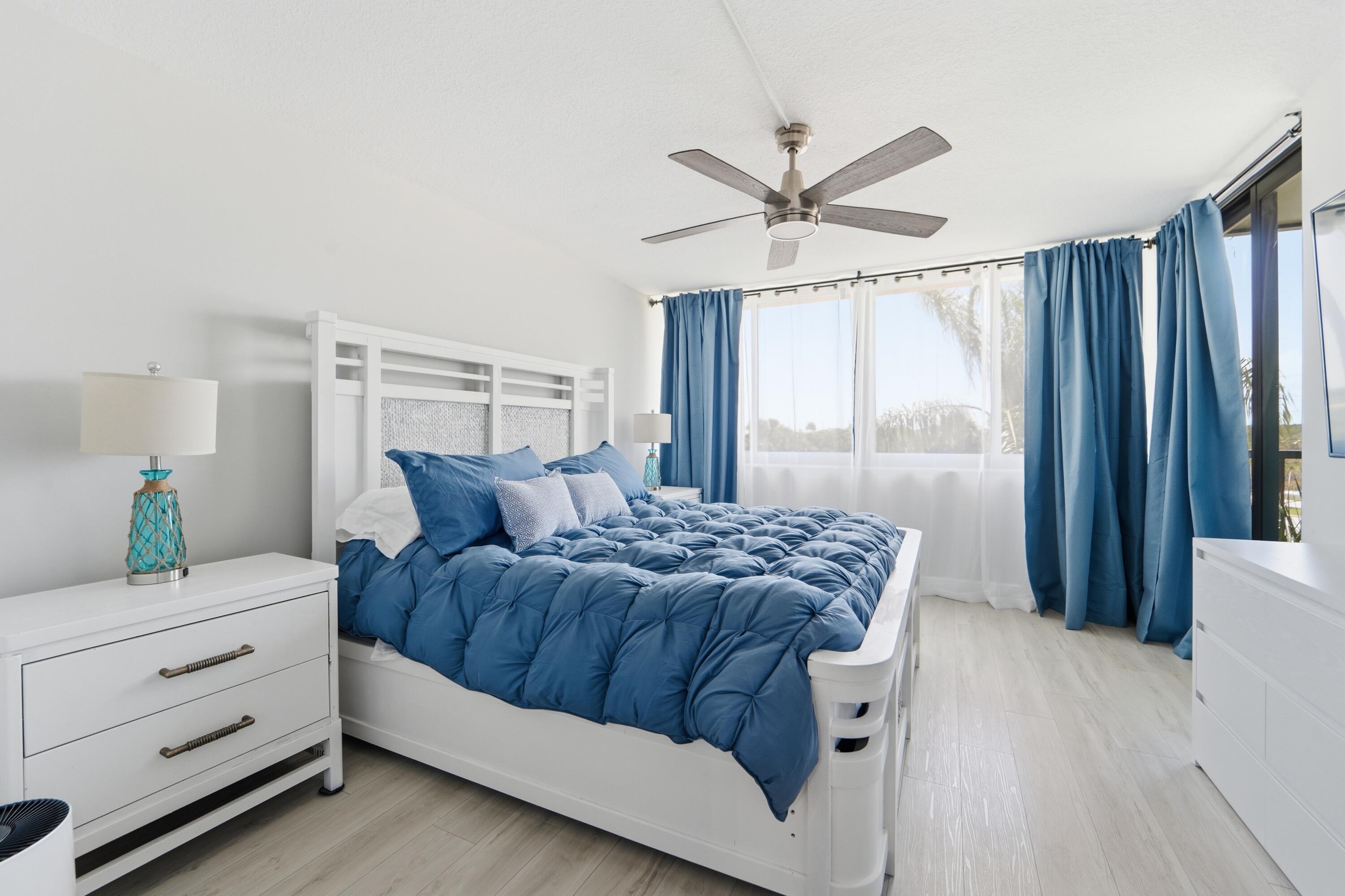 1605 Highway 1, Unit 303M1 Jupiter, FL 33477 - Photo 13 of 42 a living room with a bed dresser and a window