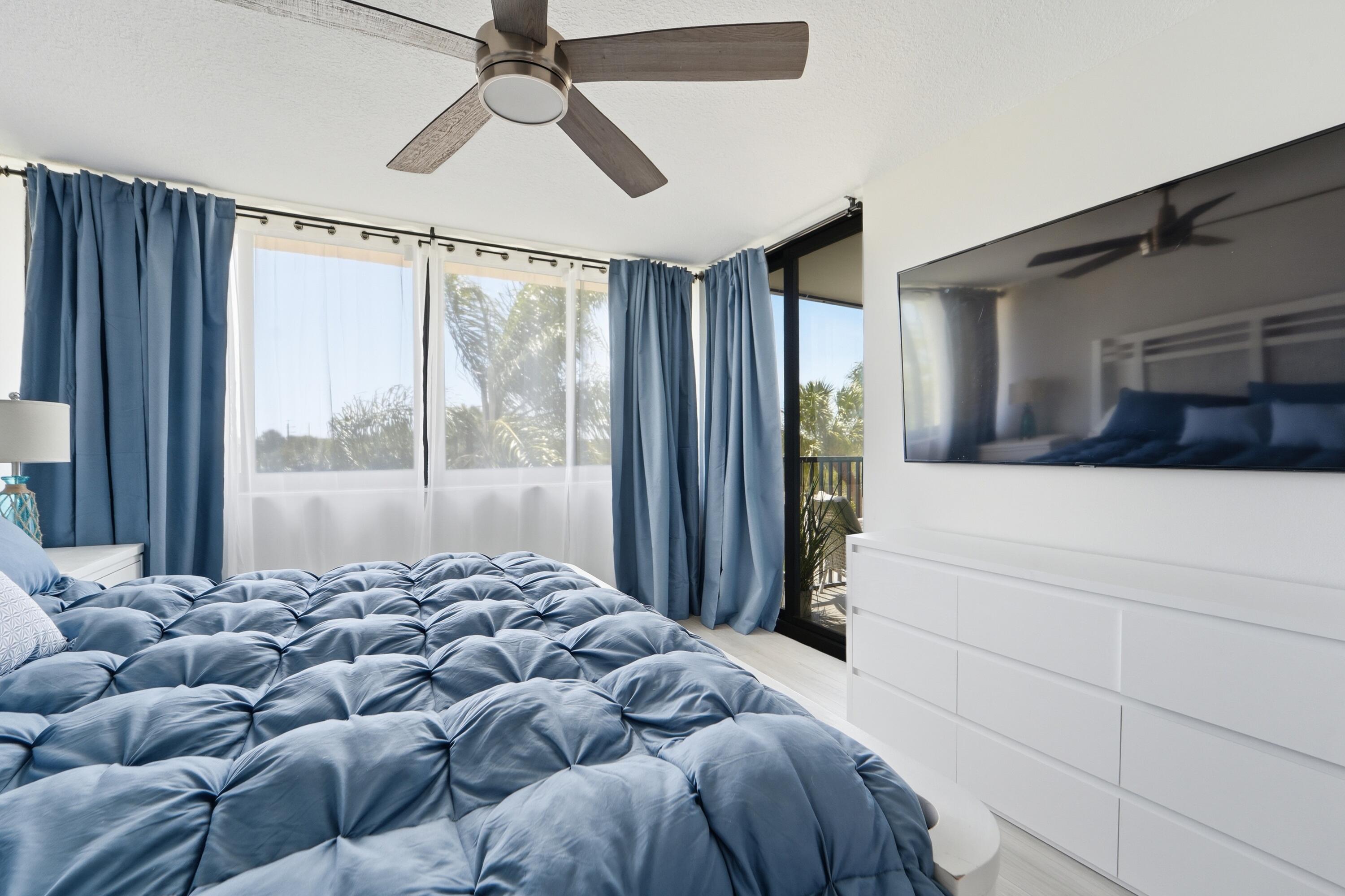 1605 Highway 1, Unit 303M1 Jupiter, FL 33477 - Photo 15 of 42 a bedroom with a large bed and a window