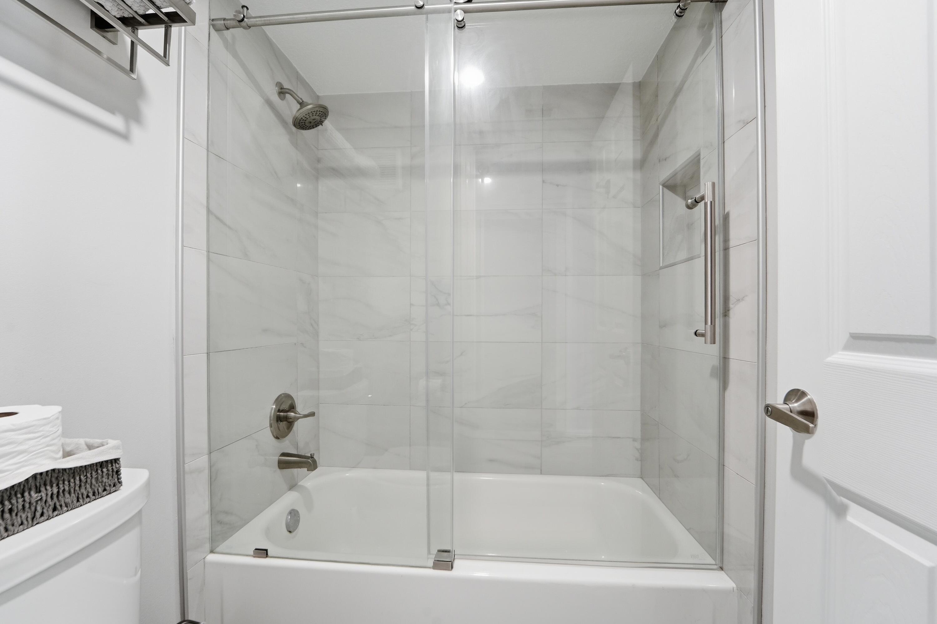 1605 Highway 1, Unit 303M1 Jupiter, FL 33477 - Photo 19 of 42 a bathroom with a tub and shower