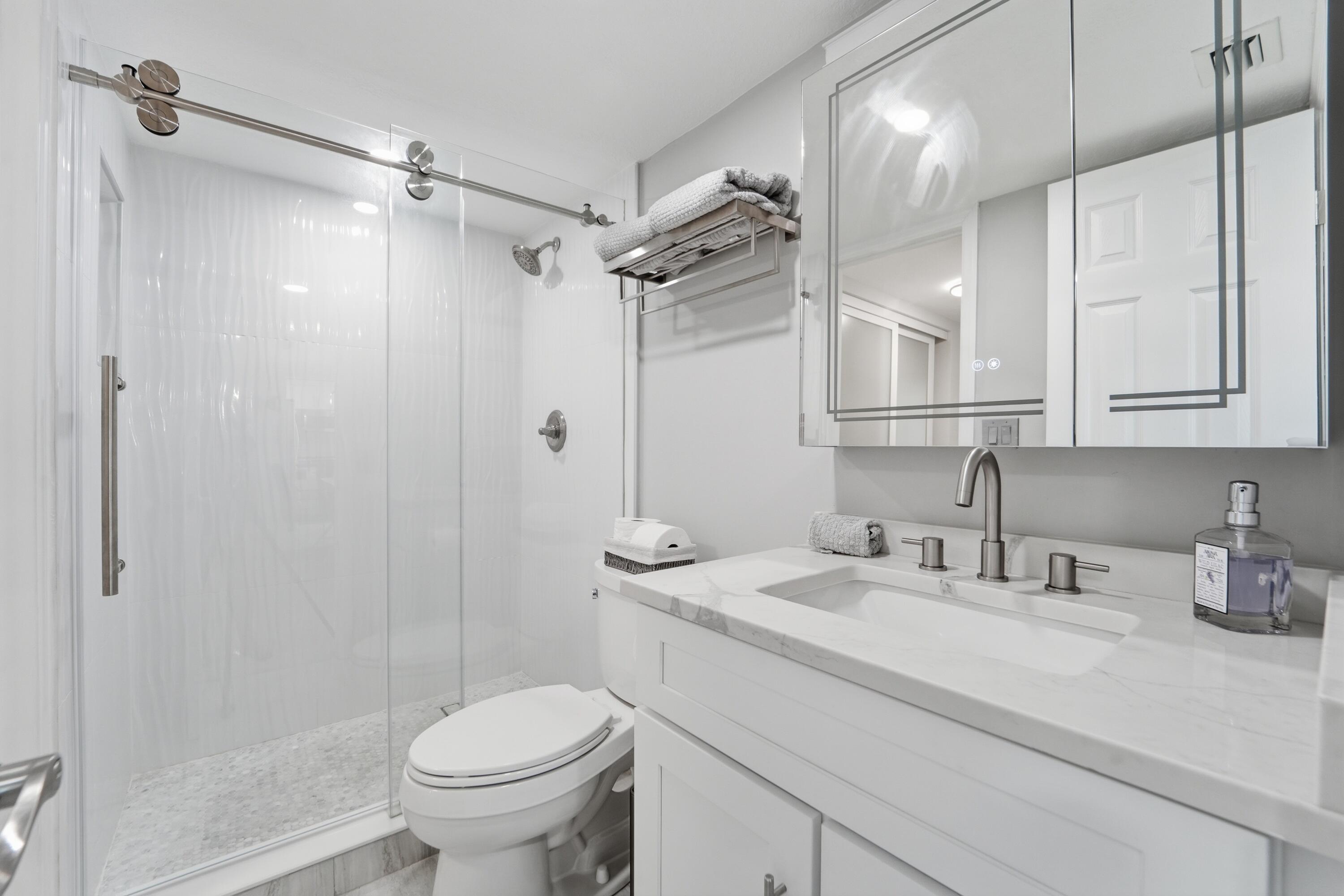 1605 Highway 1, Unit 303M1 Jupiter, FL 33477 - Photo 24 of 42 a bathroom with a sink toilet and shower