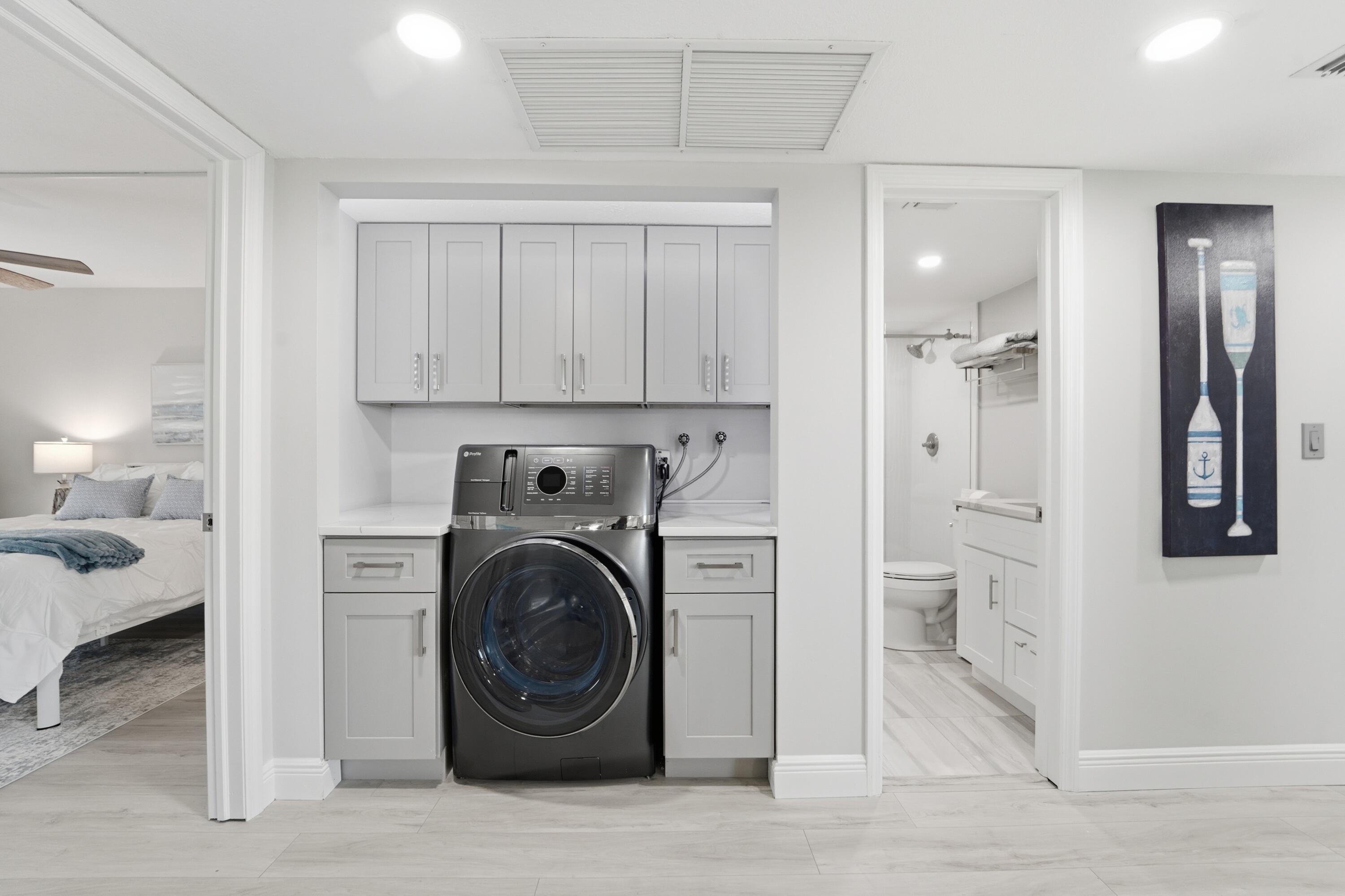 1605 Highway 1, Unit 303M1 Jupiter, FL 33477 - Photo 26 of 42 a view of a hallway with washer and dryer