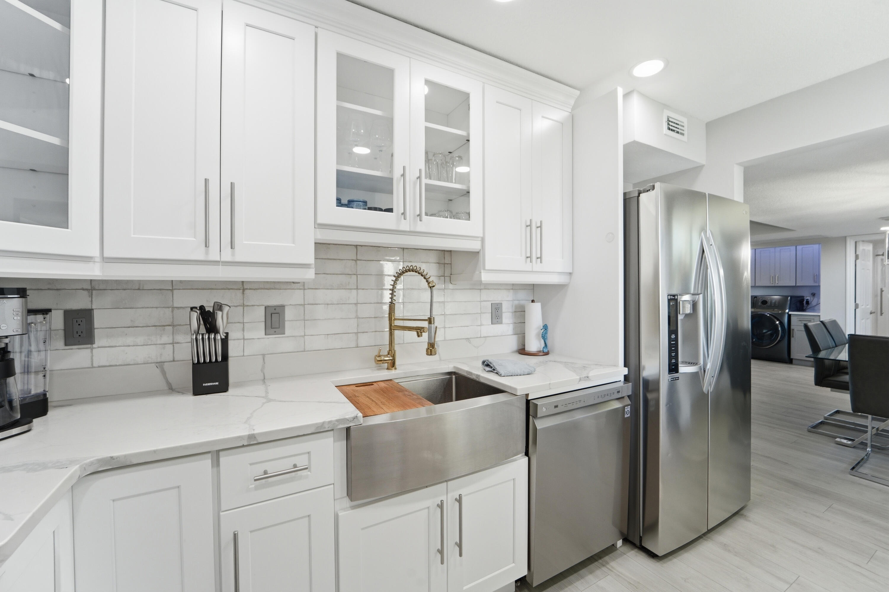 1605 Highway 1, Unit 303M1 Jupiter, FL 33477 - Photo 27 of 42 a kitchen with stainless steel appliances granite countertop a sink stove and refrigerator