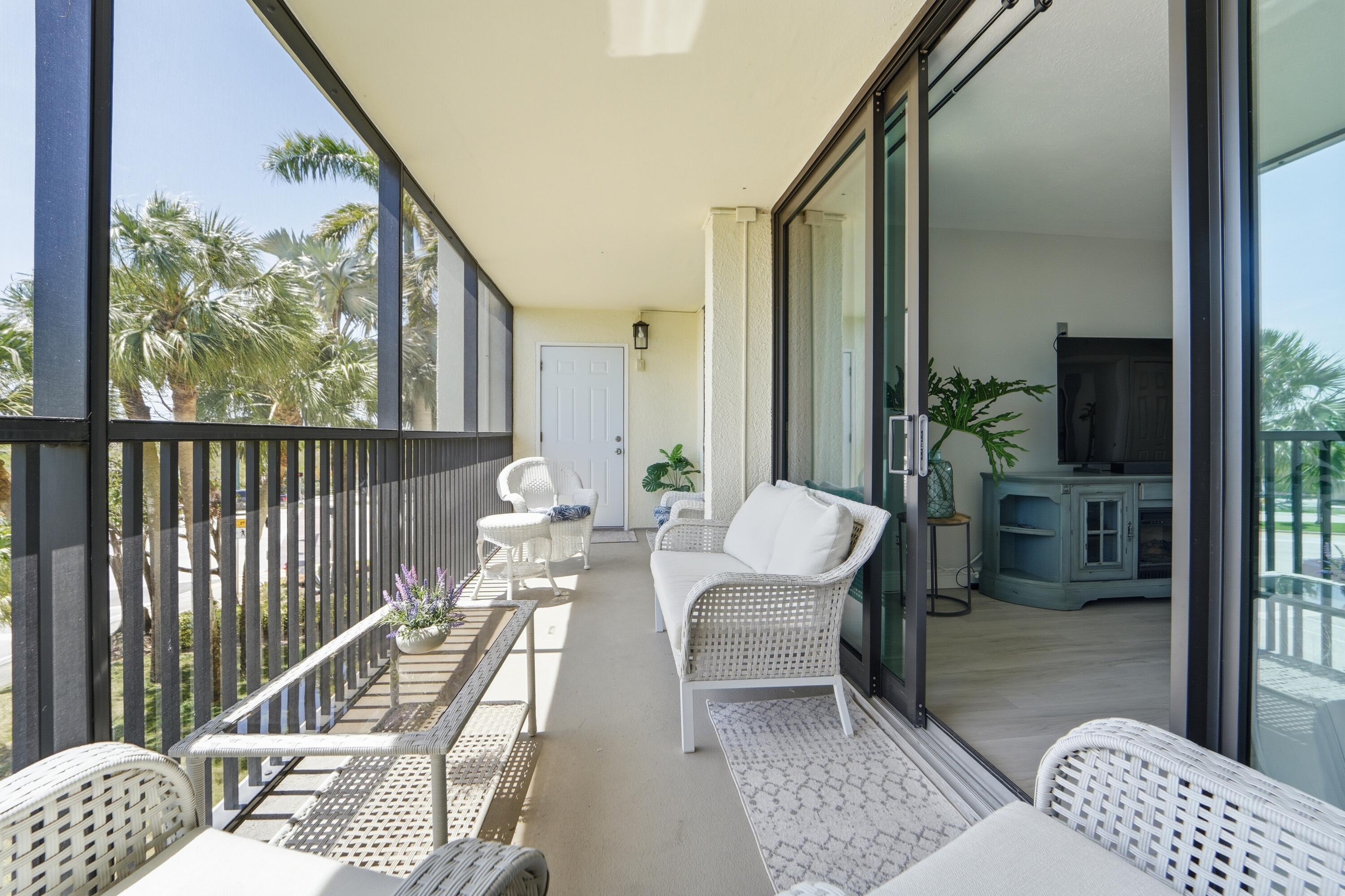 1605 Highway 1, Unit 303M1 Jupiter, FL 33477 - Photo 32 of 42 a living room with furniture and a floor to ceiling window