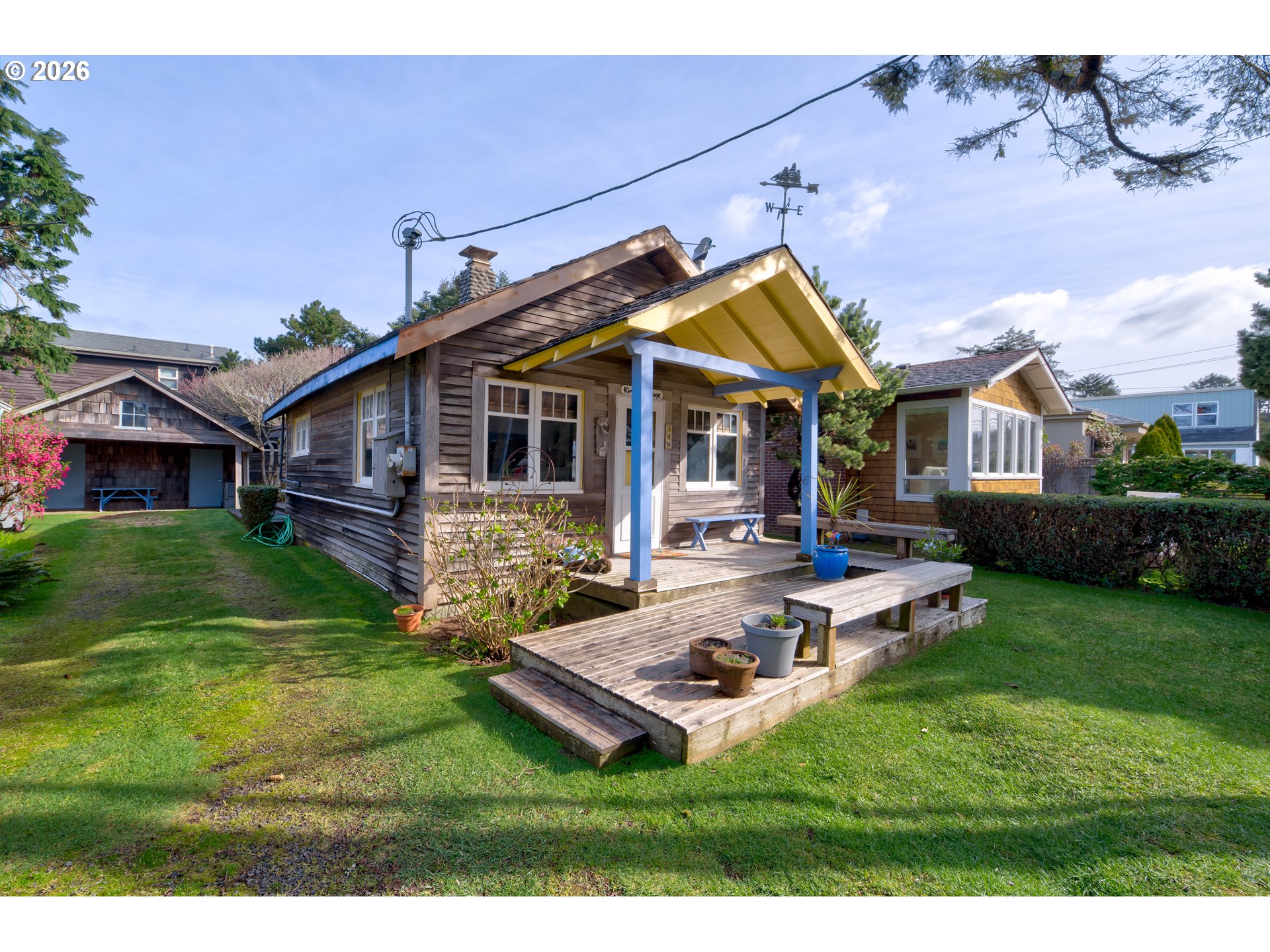 a view of a house with backyard and sitting area