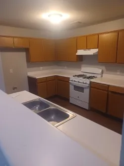 a kitchen with granite countertop a sink and cabinets
