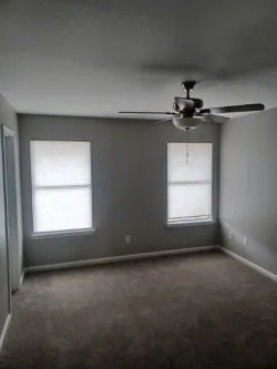 an empty room with a empty space and windows