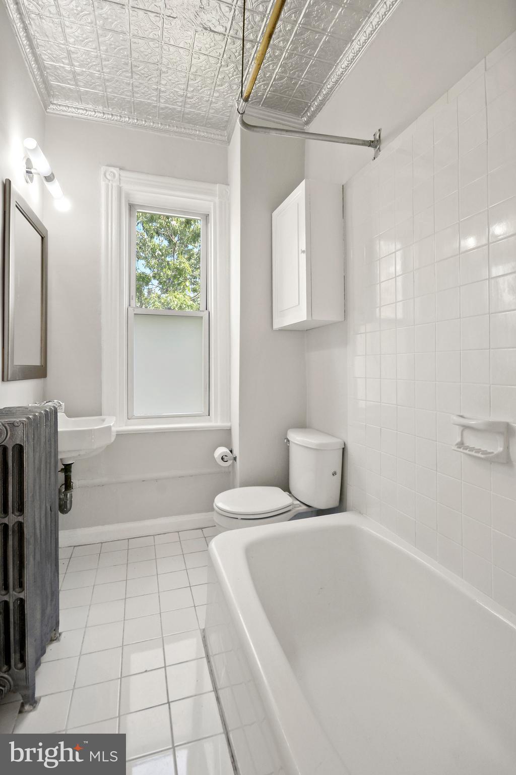 215 9th Street Northeast Washington, DC 20002 - Photo 23 of 26 Original tin ceiling and cast iron bath