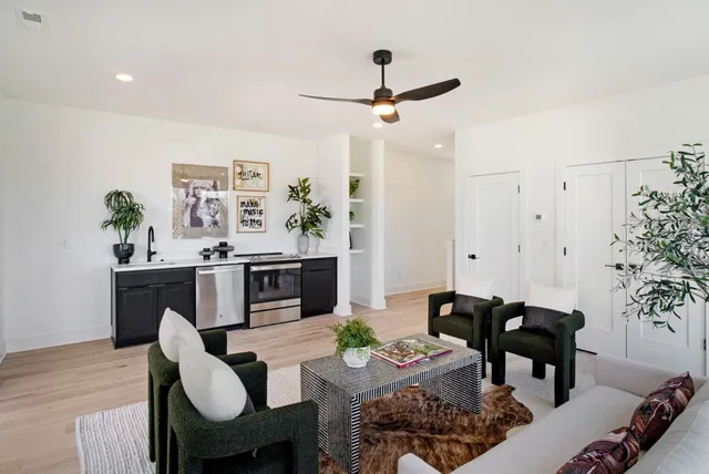 a living room with furniture a dining table and a potted plant