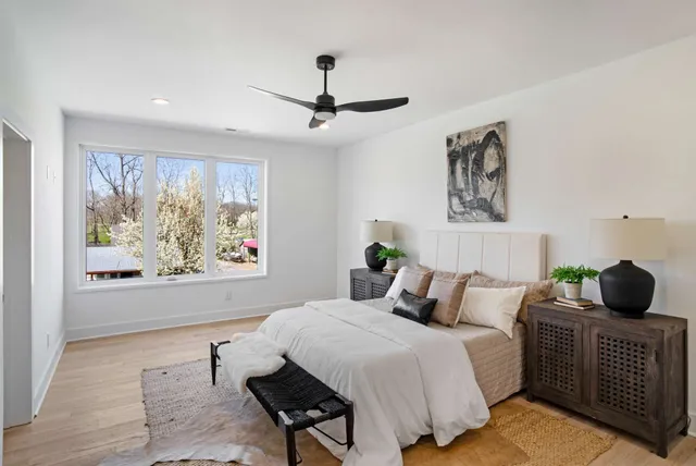 a bedroom with a bed a couch and a window