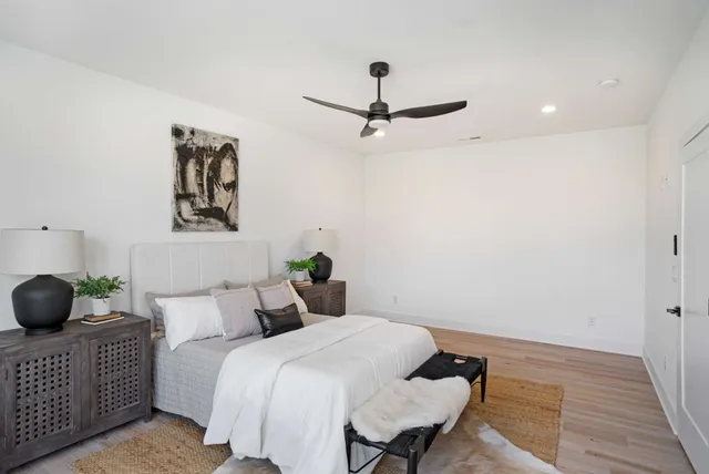 a bedroom with a bed and wooden floor