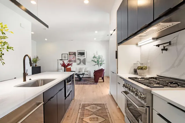 a kitchen with stove a sink and a refrigerator