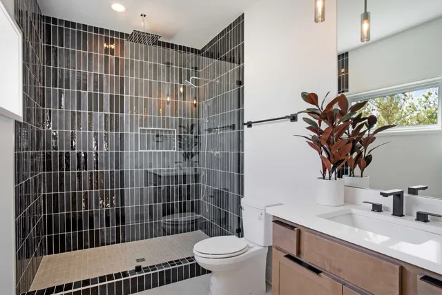 a bathroom with a sink toilet and shower