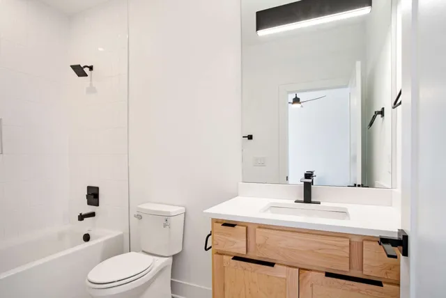 a bathroom with a sink toilet and shower