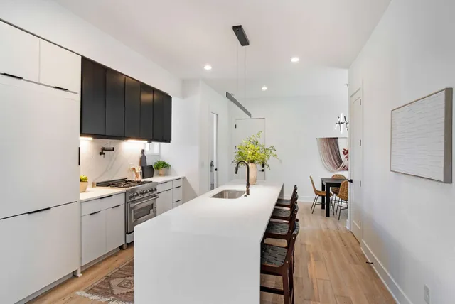 a kitchen with stainless steel appliances a stove sink microwave and cabinets