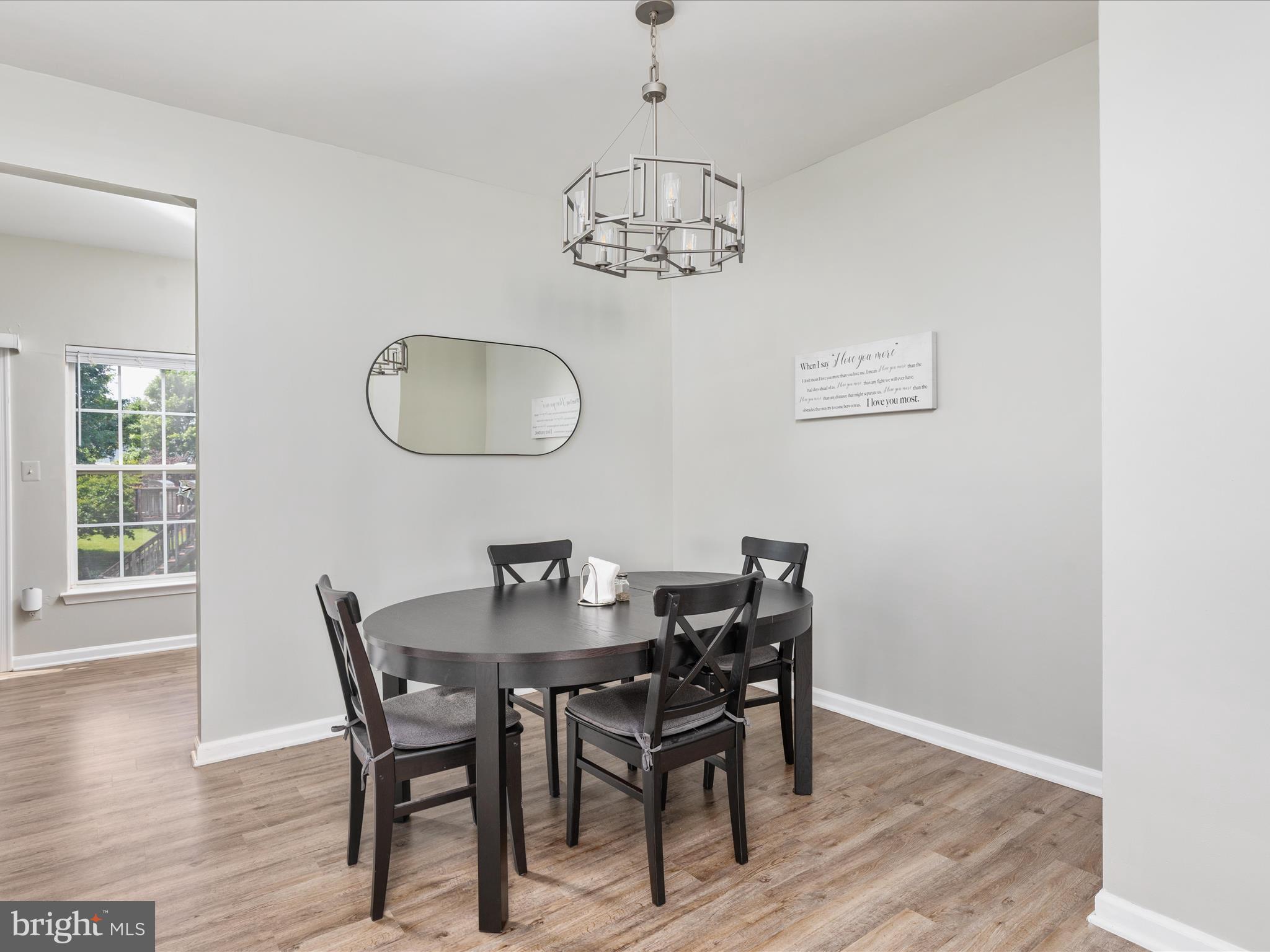 7100 Wheeling Way Gainesville, VA 20155 - Photo 11 of 39 a view of a dining room with furniture and wooden floor